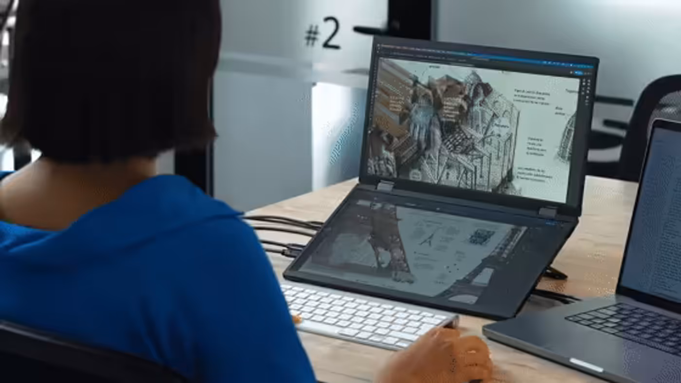 Dual-screen folding monitor displaying detailed CAD design work